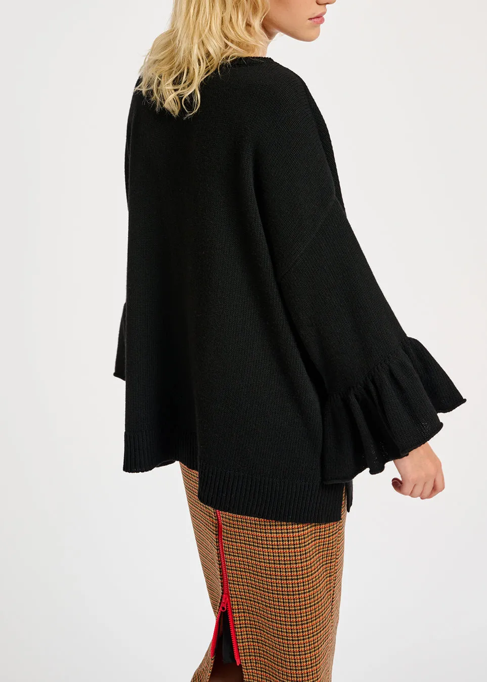 Black knit sweater with ruffled cuffs