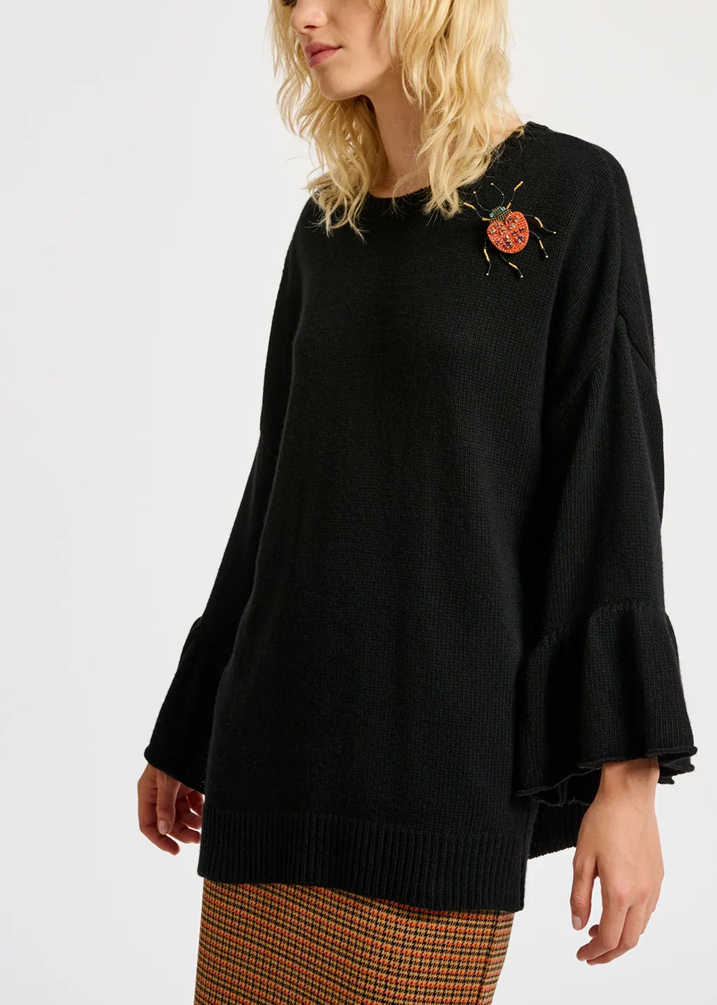 Black knit sweater with ruffled cuffs