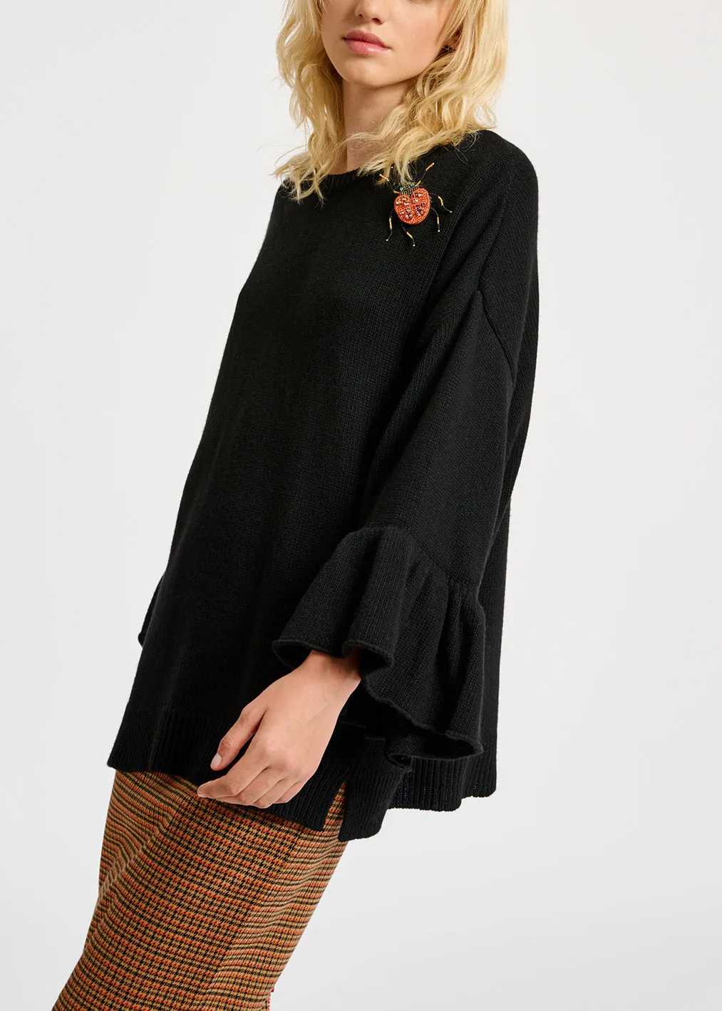 Black knit sweater with ruffled cuffs